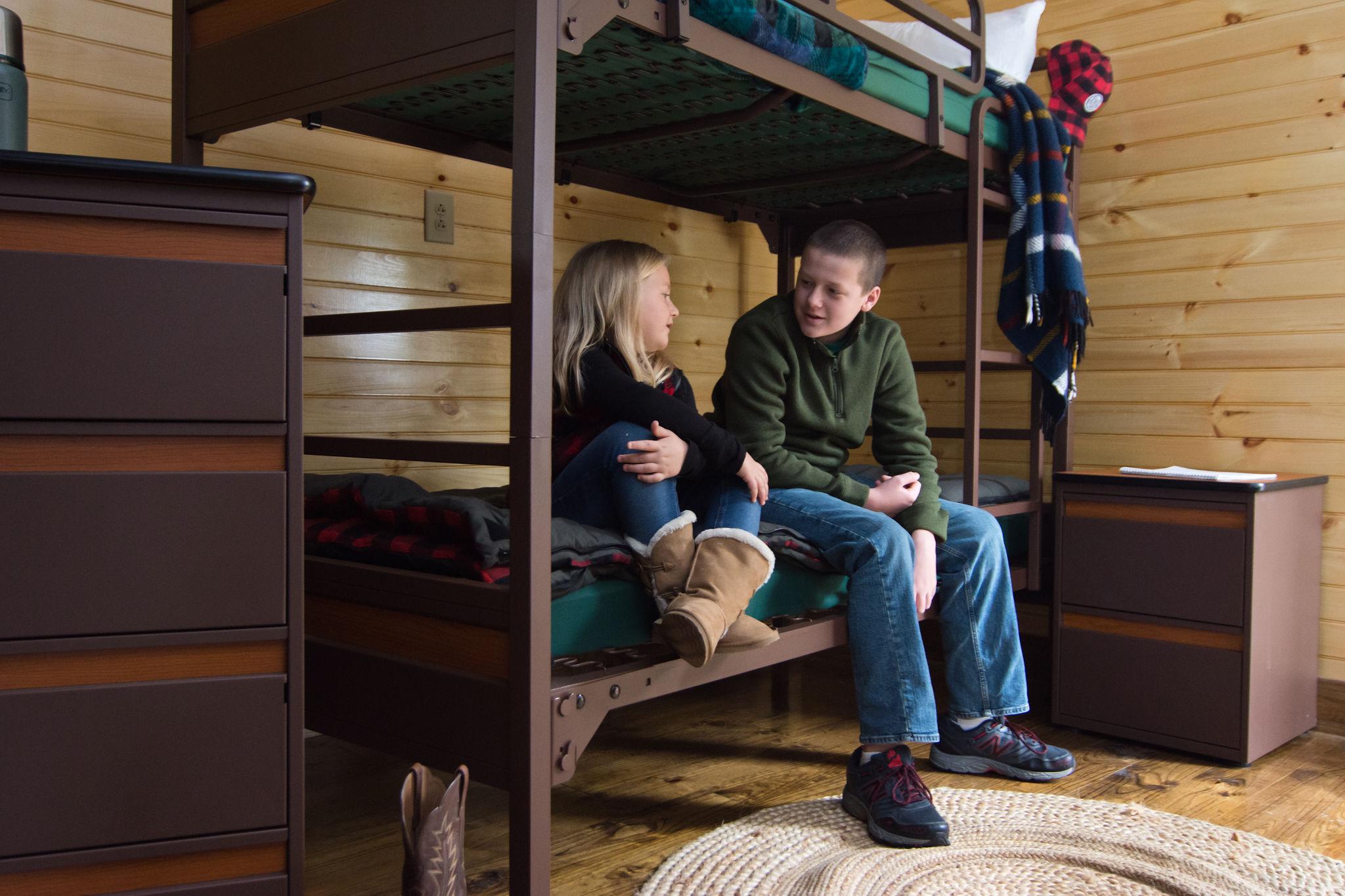 camp bunk bed with two kids talking